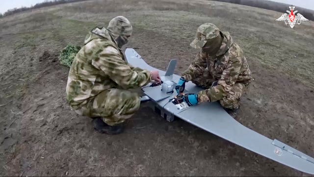 Russian servicemen prepare a drone in an undisclosed location in Ukraine