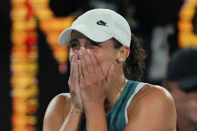 Madison Keys covers up her face as she celebrates her victory