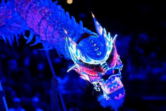 Performers make a presentation to honor the Lunar New Year of the Snake before an NBA basketball game between the Washington Wizards and the Dallas Mavericks