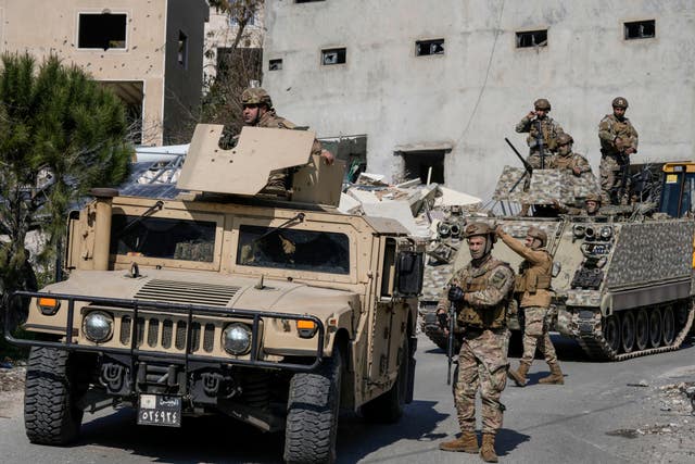 Soldiers next to armoured truck