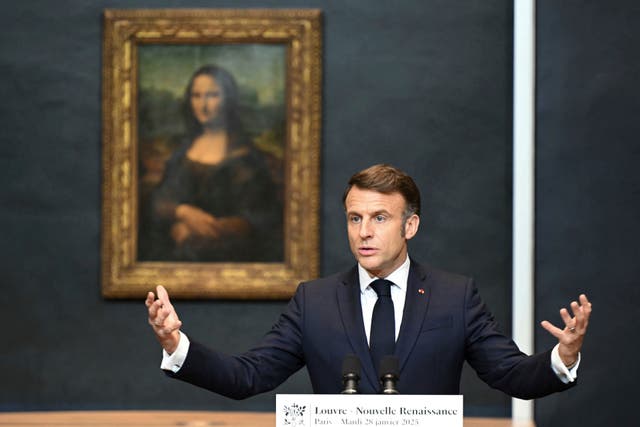 Emmanuel Macron speaks in front of the Mona Lisa