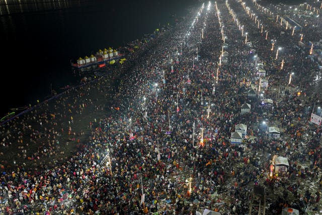 Hindu devotees gather to take a holy dip in the Sangam,