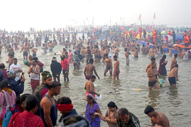 Hindu devotees take a holy dip in the Sangam,