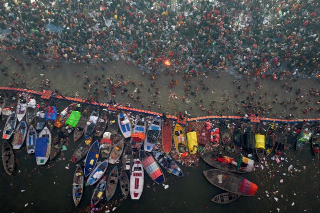 Hindu devotees gather to take a holy dip in the Sangam