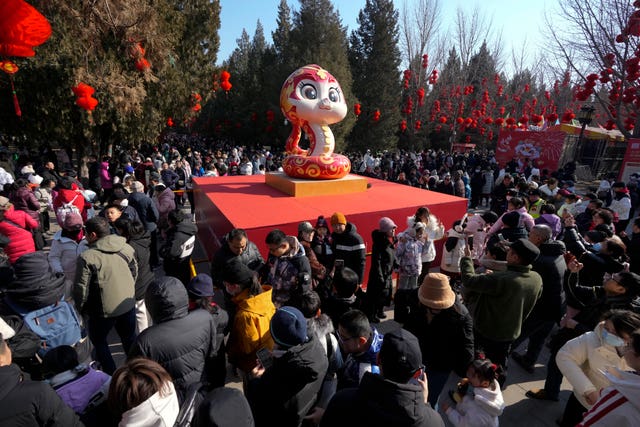 A snake figure is displayed as people gather at the Ditan Temple Fair on the first day of the Chinese Lunar New Year in Beijing