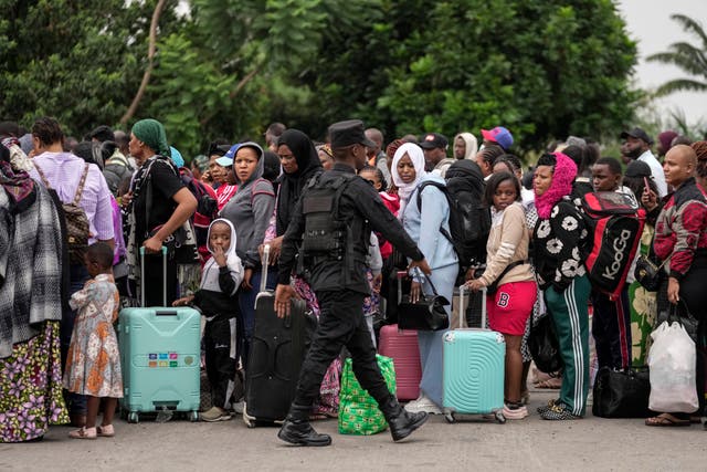 Rwanda security officials check people crossing from Congo in Gisenyi