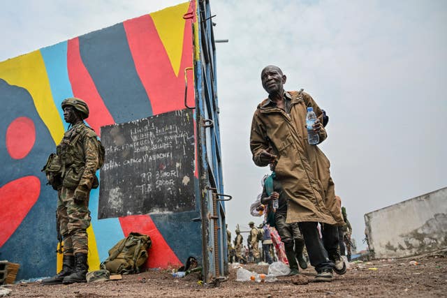 Government soldiers and police officers who surrendered to M23 rebels board trucks to an undisclosed location in Goma