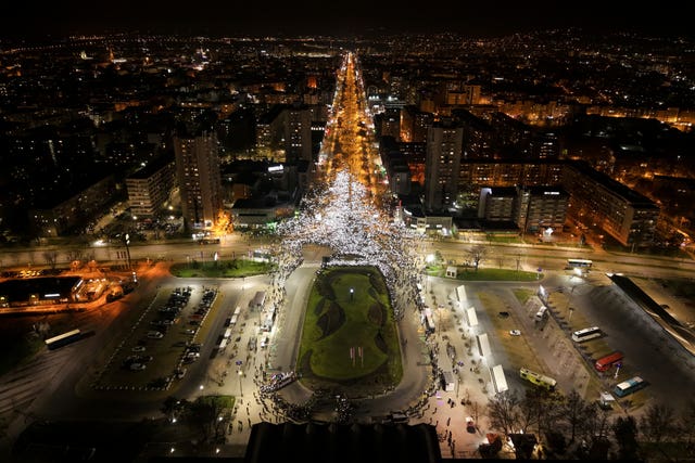 An overhead view of a boulevard lit up by mobile phone lights in Novi Sad