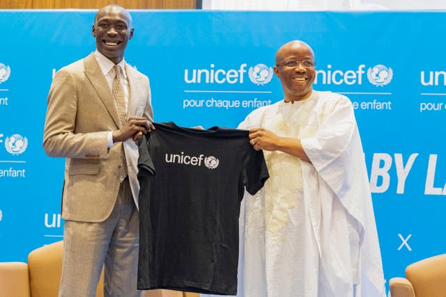 TikTok star Khaby Lame receives a T-shirt from Unicef regional director for West and Central Africa Gilles Fagninou in Dakar, Senegal 