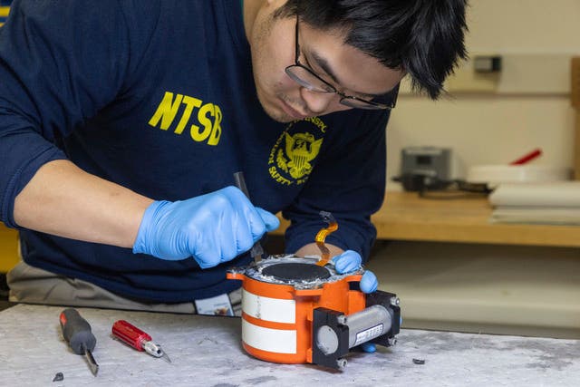 Investigators examine cockpit voice recorder and flight data recorder recovered from the American Airlines passenger jet that crashed with an Army helicopter 