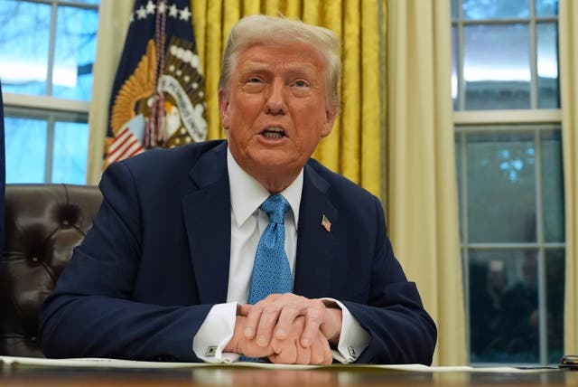 Donald Trump speaking at his desk in the Oval Office