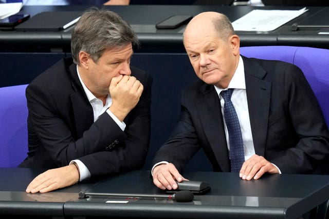 German Chancellor Olaf Scholz, right, chats with German economy and climate minister Robert Habeck during a session of the German parliament in Berlin