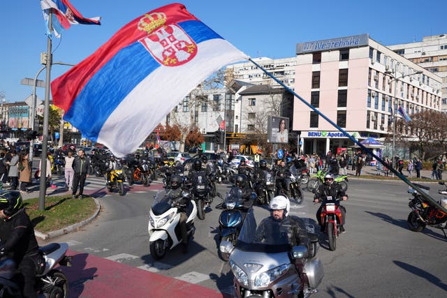 Protesters wave the national flag