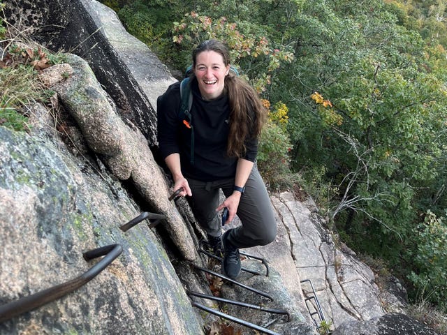 Cpt Rebecca M Lobach on a cliff