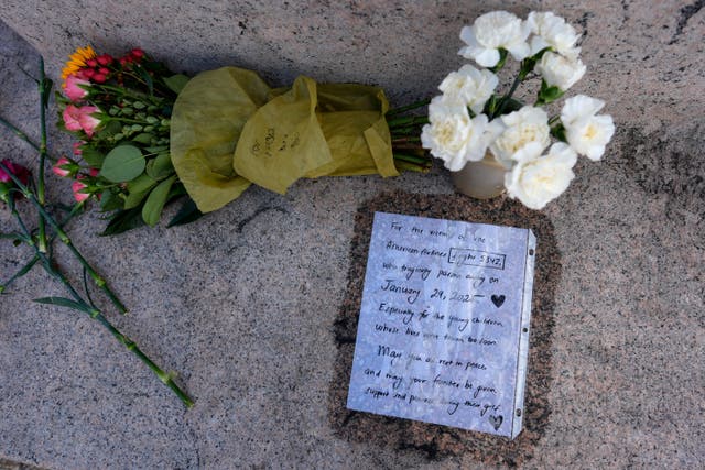 Flowers and a letter in memorial to the victims of a plane crash