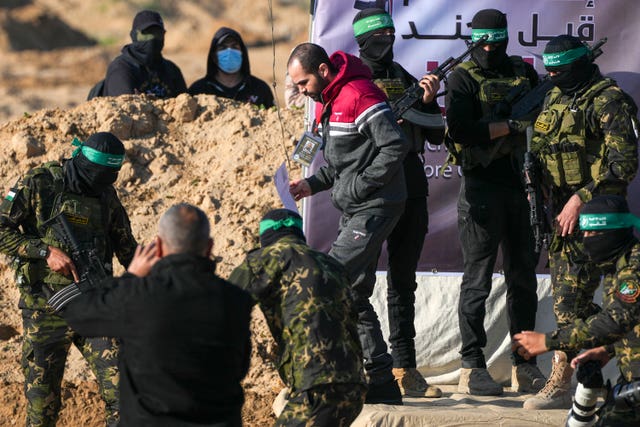 Yarden Bibas is escorted by Hamas fighters