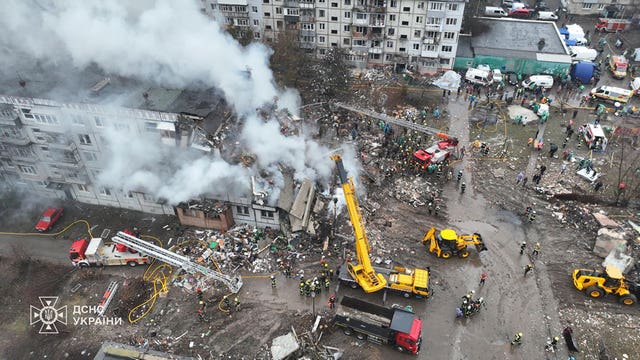 Firefighters putting out a fire in a apartment building following a Russian rocket attack in Poltava, Ukraine