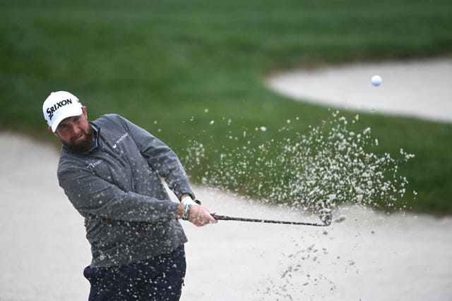 Shane Lowry, of Ireland, hits out of a bunker on the 17th