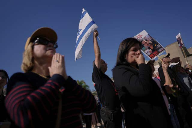 Israelis react as they watch a broadcast of the release of American-Israeli Keith Siegel