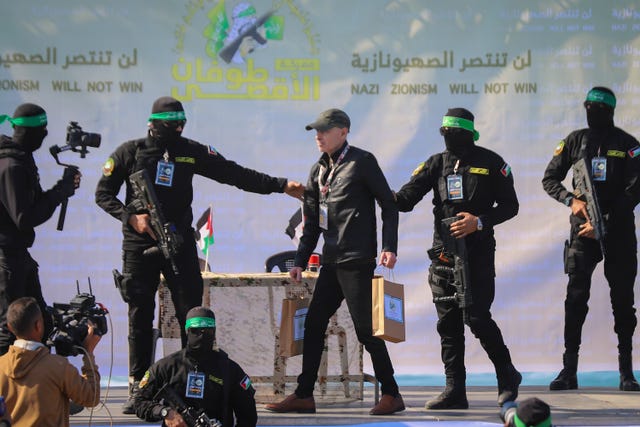 American-Israeli hostage Keith Siegel, 65, is escorted by Hamas fighters as he is handed over to the Red Cross in Gaza City