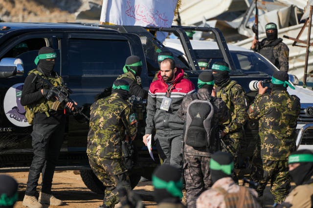 Freed prisoner surrounded by Hamas fighters