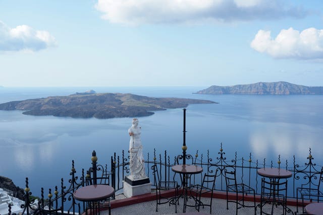 The volcanic island of Nea Kameni, left, is seen from Fira town