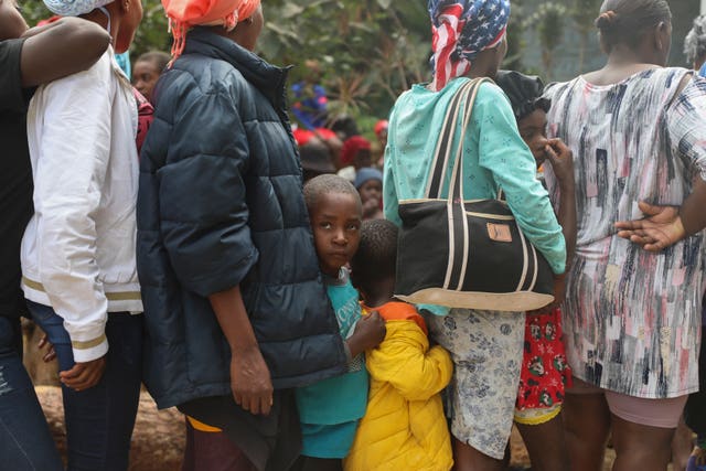 People line up to receive food at a shelter for families displaced by gang violence in the Kenscoff area of Port-au-Prince