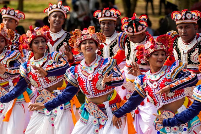 People in colourful dress march as a group