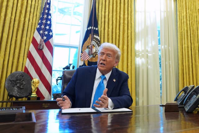 Donald Trump at his desk in the Oval Office