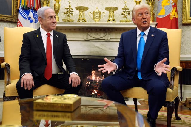 Donald Trump speaking while sitting alongside Benjamin Netanyahu in front of a fireplace