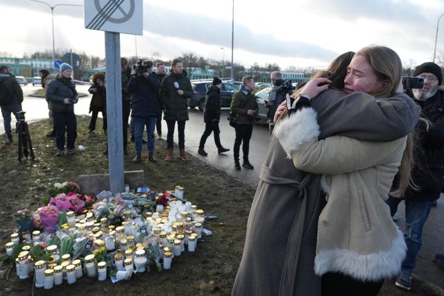 People hugging at memorial