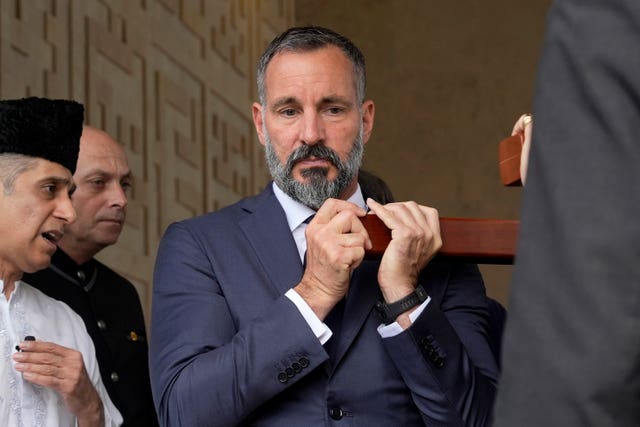 Prince Rahim Al-Hussaini, who was named on Wednesday as the new Aga Khan, helps carry the coffin 