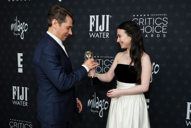 Sean Baker, left, and Mikey Madison, winners of the award for best picture for Anora, pose in the press room during the 30th Critics Choice Awards at the Barker Hangar in Santa Monica, California