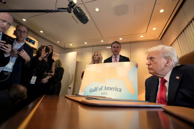 President Donald Trump speaks to reporters accompanied by Interior Secretary Doug Burgum and Burgum’s wife Kathryn Burgum, aboard Air Force One where he signed a proclamation declaring February 9 Gulf of America Day