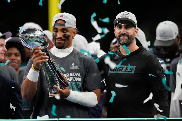 Philadelphia Eagles quarterback Jalen Hurts, left, holds the Vince Lombardi Trophy