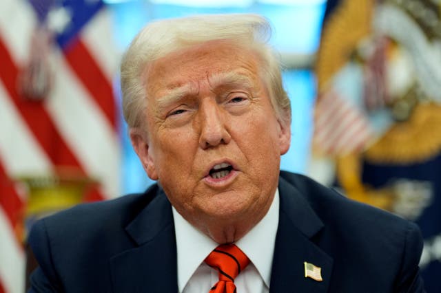 President Donald Trump speaks with reporters as he signs an executive order in the Oval Office at the White House