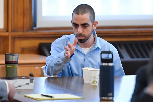 Hadi Matar, charged with severely injuring author Salman Rushdie in a 2022 knife attack, speaks to his defence team in Chautauqua County court in Mayville, New York 