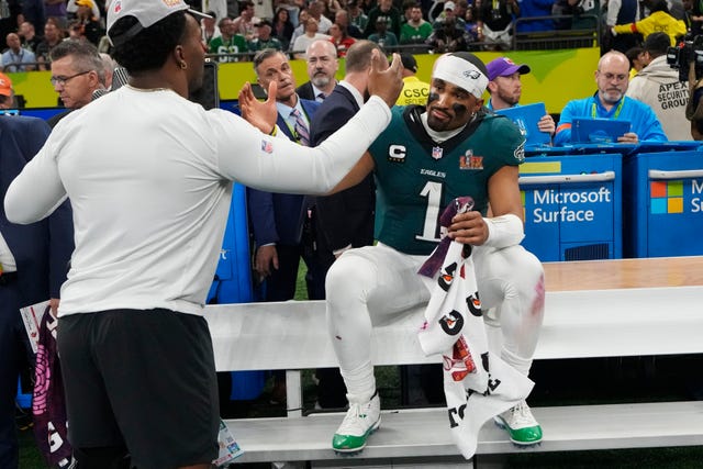 Philadelphia Eagles quarterback Jalen Hurts celebrates on the bench