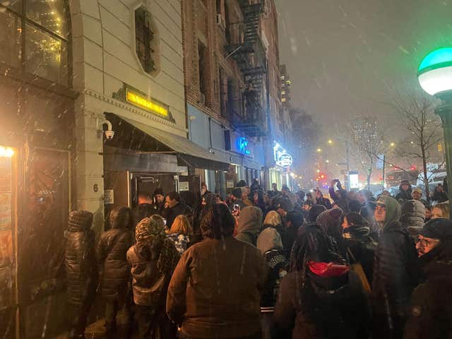 People gather outside the Bowery Ballroom where Paul McCartney’s surprise show was held in New York