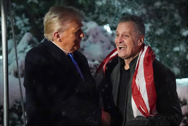 President Donald Trump greets Marc Fogel on the South Lawn at the White House