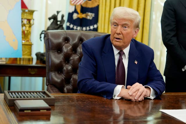 Donald Trump at his desk in the Oval Office