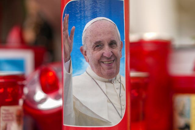 A candle with a picture of the Pope