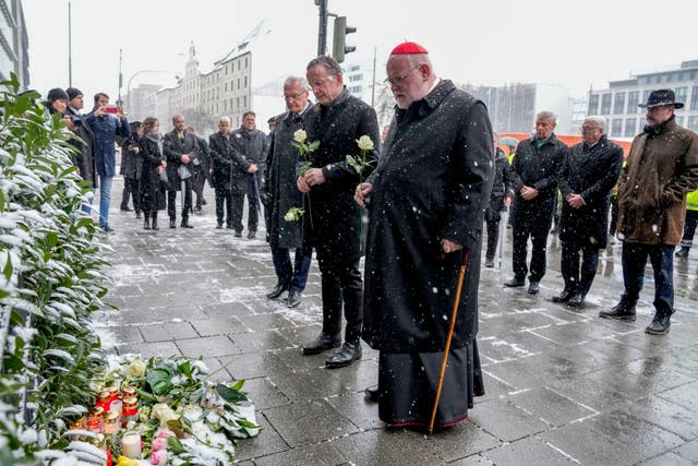 Munich Bishop Reinhard Marx, centre, and Markus Soeder, prime minister of Bavaria, German president Frank-Walter Steinmeier and Dieter Reiter (SPD), mayor of Munich, lay flowers at the site where a car crashed into a demonstration the day before in Munich, Germany