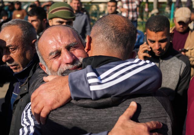 Two men hugging, in a crowd