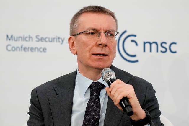 Edgars Rinkevics speaking into a microphone at the Munich Security Conference