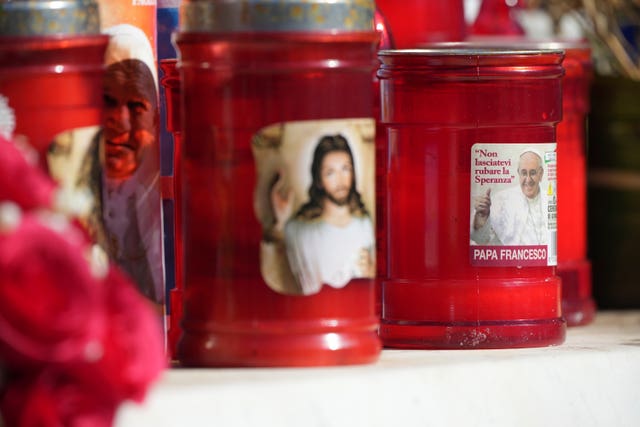 Candles featuring pictures of Jesus and Pope Francis