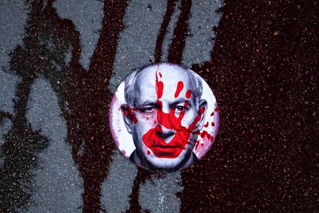 A sticker on a road with the face of Benjamin Netanyahu