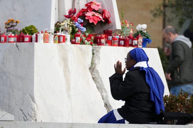 A nun sits in front of the main entrance of the Agostino Gemelli Polyclinic in Rome 