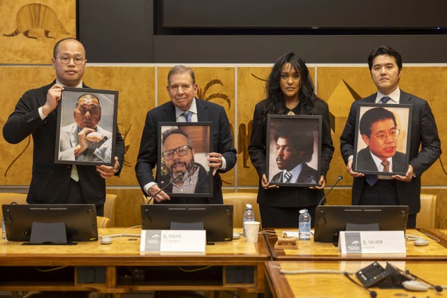 Sebastien Lai and others hold up pictures of detained people