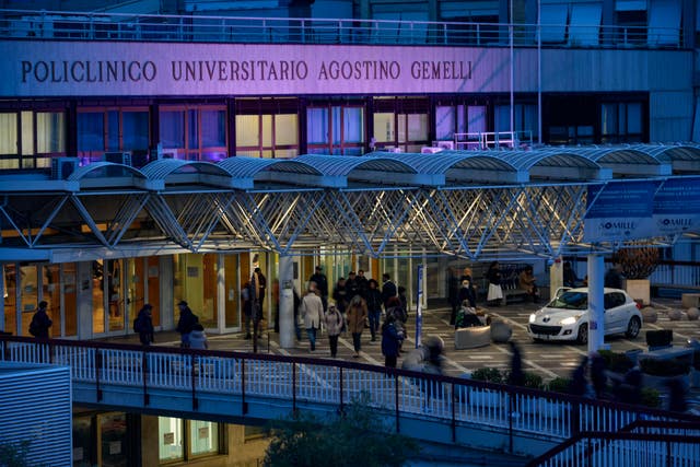 People walk in front of the main entrance of the Agostino Gemelli Polyclinic in Rome